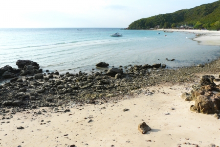 Beautiful sea, rock beach and mountainの写真素材