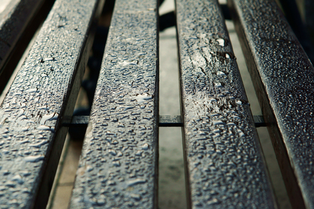 raindrops on a bench, wet wooden boardsの写真素材