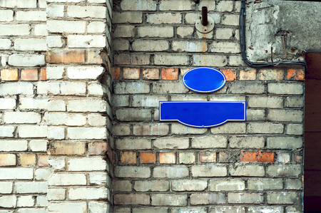 a pointer to the name of the street a sign on the wall of the building on the streetの写真素材