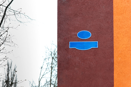 a pointer to the name of the street a sign on the wall of the building on the streetの写真素材