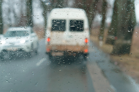 rain on glass, drive on highway in heavy rain, raindrops on car glass, wet asphaltの写真素材