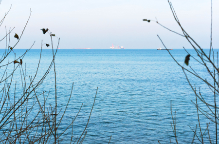 sea waves and clouds in the sky, oil and gas installations in the seaの写真素材