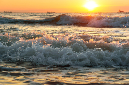 sunset on the sea, sunrise in the waves of the seaの写真素材