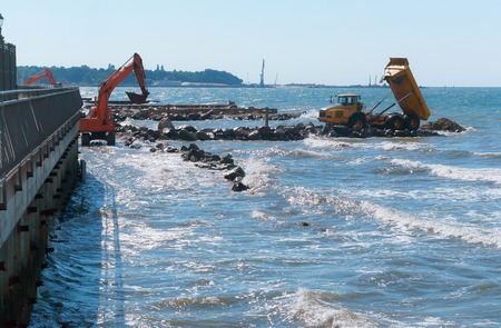 construction equipment on the shore, the construction of breakwaters, coastal protection measuresの写真素材