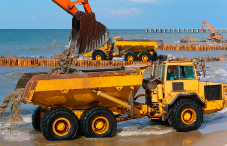 construction equipment on the shore, the construction of breakwaters, coastal protection measuresの写真素材
