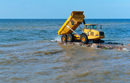 construction equipment on the shore, the construction of breakwaters, coastal protection measuresの写真素材