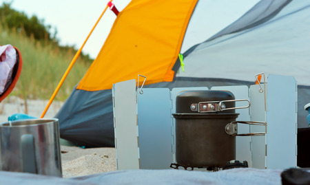 camping burner and tent, tourist gas burner and yellow tentの写真素材