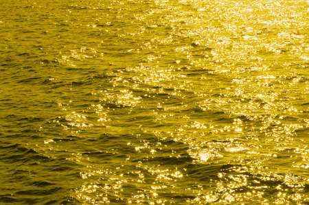 yellow tone, background water surface, ripple on the waterの写真素材
