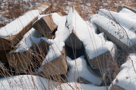 construction waste in nature, construction waste in the field under the snowの写真素材