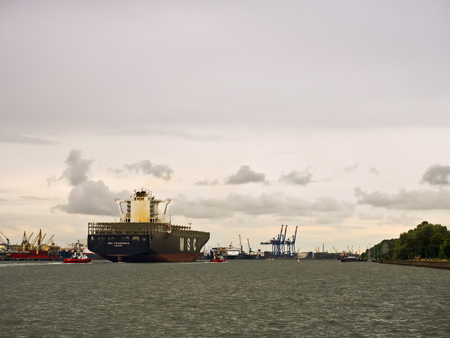 port canal, empty container ship, cargo ship with escort, 24 June 2018, Baltic sea, Klaipeda, Lithuaniaのeditorial素材