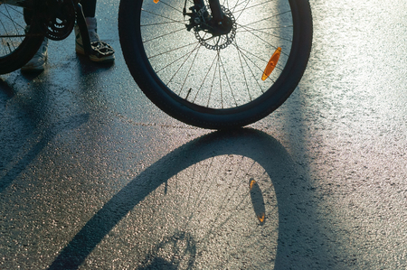 bike on wet roads, the reflection and shadow of a Bicycle wheelの写真素材