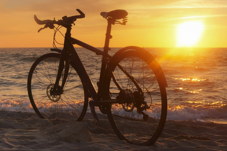 the silhouette of a Bicycle on the beach, Bicycle at sunsetの写真素材