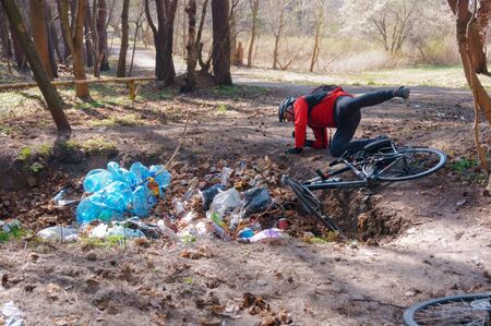the man fell off his bike, household rubbish in the forest, Pionerskiy, Kaliningrad region, Russia, April 21, 2019のeditorial素材