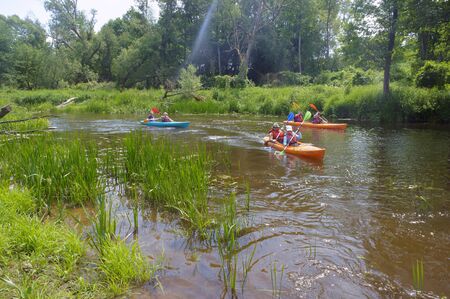 kayaking on the river, three kayaks go on the river, Angrapa river, Kaliningrad region, Russia, Eastern Europe, June 15, 2019のeditorial素材