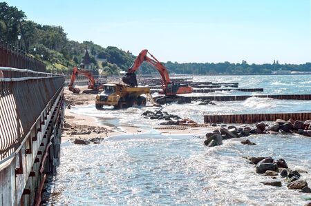 construction equipment on the seashore, construction of breakwaters in the Baltic sea, Baltic sea, Kaliningrad region, Russia, July 15, 2018のeditorial素材