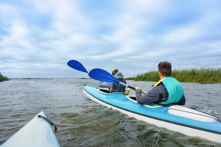 young people rafting on the river, kayaking on a calm river, Matrosovka river, Slavsky district, Kaliningrad region, Russia, September 21, 2019のeditorial素材