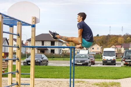 sports man on uneven bars, a man trains on the Playground, Kaliningrad region, Russia, October 19,...