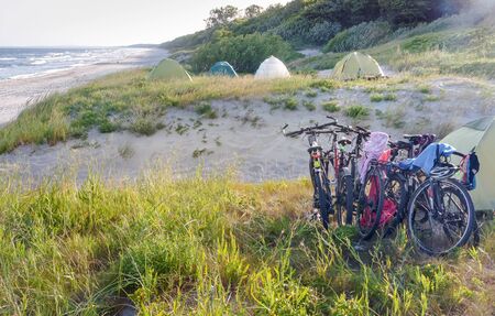 cyclists tourists on the beach, tourist camping and bicycles on the seashore, Kaliningrad region, Russia, June 30, 2019のeditorial素材