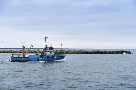 blue fishing boat, small fishing vessel, Baltic sea, Kaliningrad region, Russia, February 3, 2019