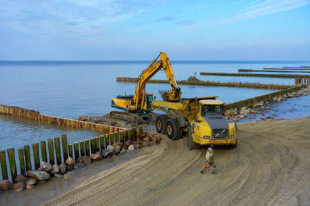 construction equipment on the shore, the construction of breakwaters, coastal protection measures, Russia, Baltic sea, Kaliningrad region, March 9, 2020のeditorial素材