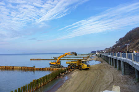 construction equipment on the shore, the construction of breakwaters, coastal protection measures, Russia, Baltic sea, Kaliningrad region, March 9, 2020のeditorial素材
