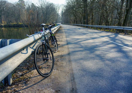 two bikes on the road, Cycling in the early morning, Russia, Kaliningrad region, March 28, 2020のeditorial素材