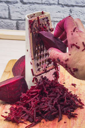 grate beetroot on a grater, fresh beet gratedの写真素材
