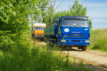 Construction equipment in the forest. Big blue truck in the woods. Russia, Kaliningrad region, June 24, 2020のeditorial素材