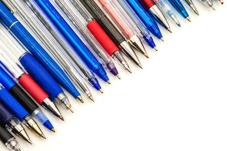lots of blue ballpoint pens, multi-colored ballpoint pens on a white background