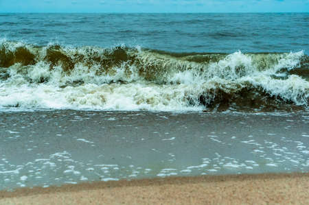 storm waves on the sea, waves and wind on the seashore, summer seascape
