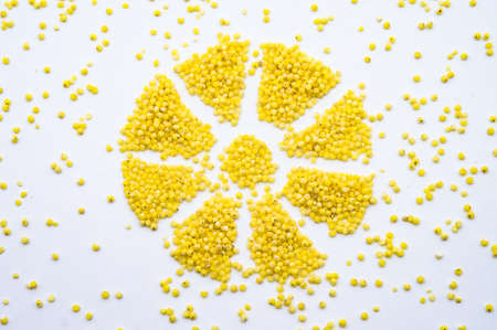 millet porridge, millet groats on a white background, snowflake from millet grains, flower from cerealsの写真素材