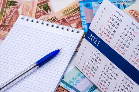 budget planning, sales strategy for the next year, Notepad and money, calendar for 2021