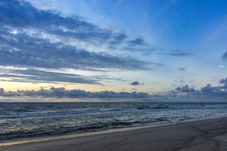 the sun sets over the horizon on the sea, sunrise on the sea, sunset on the sea coastの写真素材