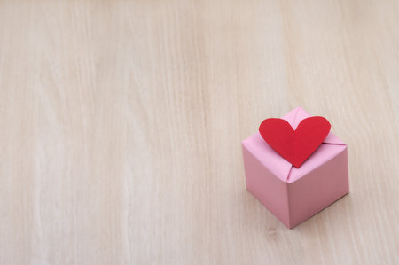 gift in pink packaging, red hearts in honor of February 14, valentine's dayの写真素材