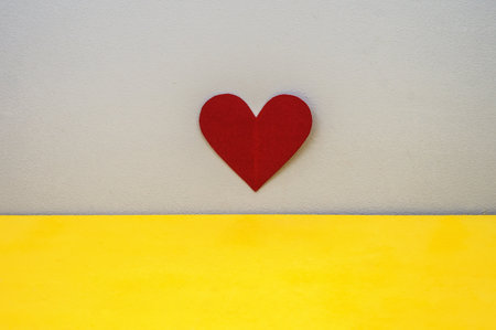 red heart, valentine's day decoration on February 14, gray and yellow background, valentine's day accessoryの写真素材
