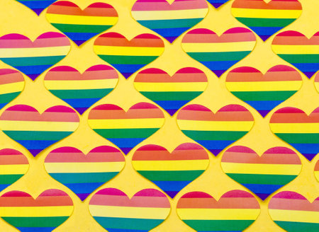 lgbt symbolism on a yellow background, background with hearts, symbol of the non-traditional communityの写真素材