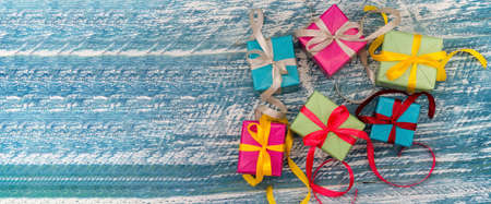 Gift boxes with origami ribbons. Blue turquoise background. Five gifts.の写真素材