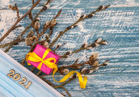 Willow twigs. Holy Easter. Blue turquoise background. Gift boxes with origami ribbons.の写真素材