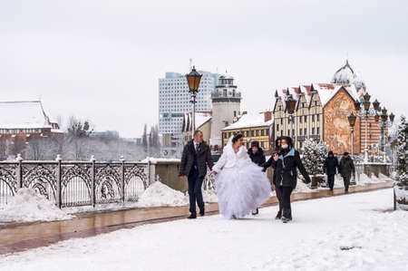 Kaliningrad, Russia, January 17, 2021. The architecture of the Fishing Village in Kaliningrad. Fish village-ethnographic and trade and craft center. Architectural style of the pre-war East Prussian city of Koenigsberg. Bride and groom on the background ofのeditorial素材