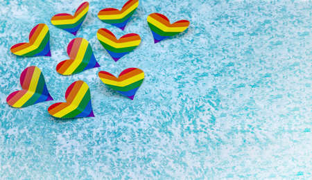 LGBT-colored paper heart. A heart made of paper on a blue background. The heart is rainbow colored. A symbol of the gay community.の写真素材