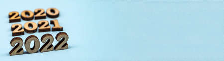 Banner 2022. Figures 2022 on blue background. Wooden figures on blue background. New Year's...