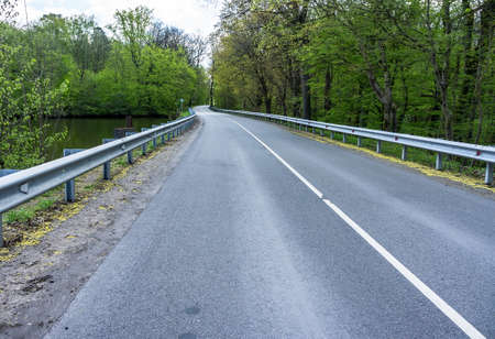 An empty highway. Long Road. Two lanes of car traffic.