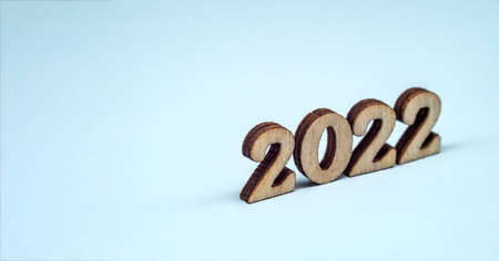 Banner 2022. Numerals 2022 on blue background. Wooden digits 2022.の写真素材