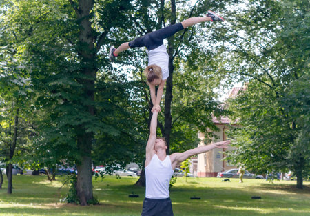 Kaliningrad, Russia, August 5, 2020. Open training of gymnasts. Acrobats practicing on the street. Workout in the park.のeditorial素材