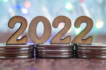Coins and Figures 2022. Banner 2022. Money stacked in columns.