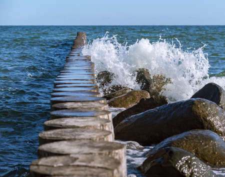 Waves and a storm at sea. Waves crashing on breakwaters. Sea wave splashing. Baltic Sea.の写真素材