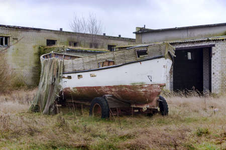 Fishing boat and nets on the shore. An old fishing boat. Russia, Kaliningrad region, 26 January,...