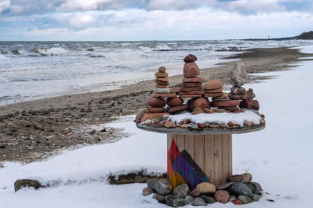 The sea stones are stacked beautifully. Zen and peaceful on the seashore. A pyramid of stones.の写真素材