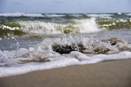 Rocky shore. The waves crash on the rocks. Sea coast. Waves and storms at sea.の写真素材