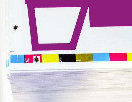 Offset printing. Sheets of printed products. CMYK press. Paper at the printing house.